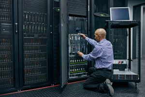 Man changing a server in a server room