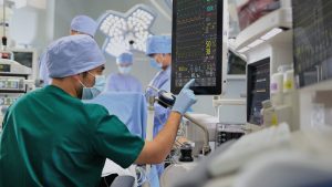 Doctor checking vitals on a monitor during surgery